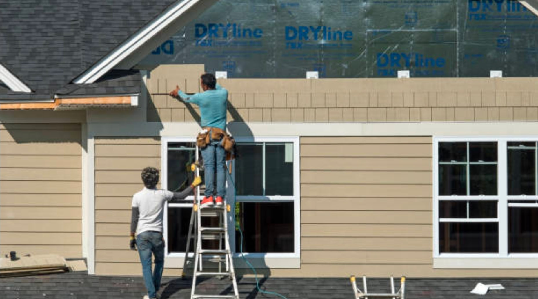 Exterior siding being installed around residential windows